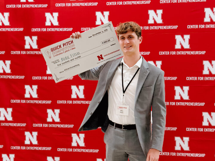 student holding a large check