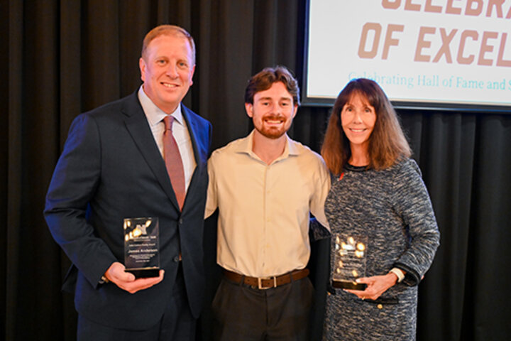 Smigielski, middle with Laura Schulte, right, and James Anderson, ’97, left