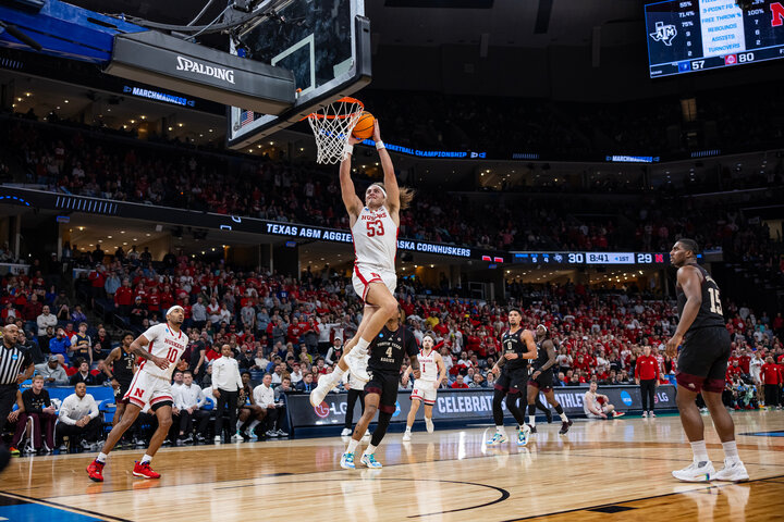 Josiah Allick shooting a basket for the Huskers.