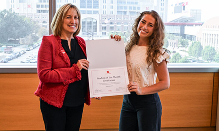Dean Kathy Farrell presents certificate to Lena in her office