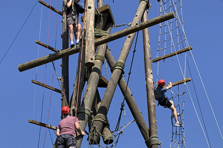 Students lead classmates through a challenge course.