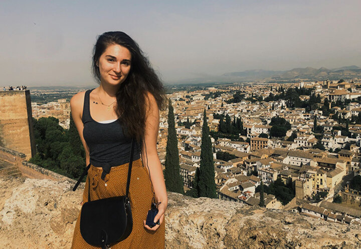 Ariel stands atop Torre del Cubo at the Alhambra. White houses are a characteristic of the Albaicín Arabic quarters in Granada.